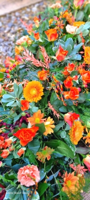 vibrant orange casket spray